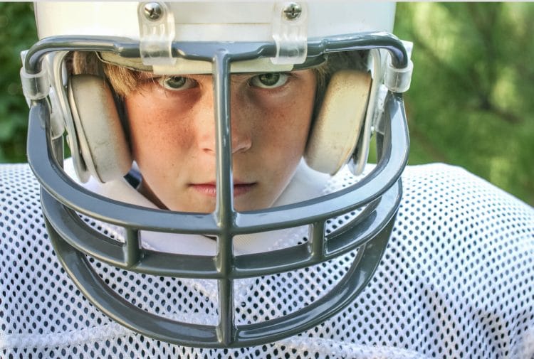 kid wearing football helmet